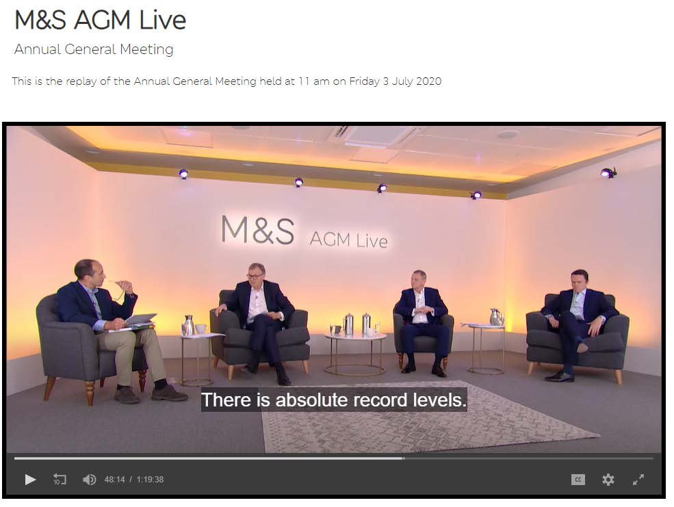 Screenshot of M&S AGM Live video showing four men discussing the meeting, with a caption "There is absolute record levels."