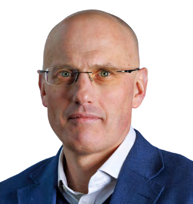 Headshot of a middle-aged man with glasses and a bald head, wearing a blue jacket.