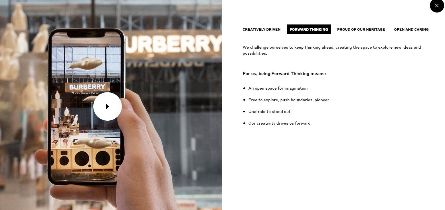 Hand holding a smartphone displaying an augmented reality object floating in a Burberry store, illustrating AR technology.