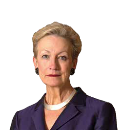 Portrait of a woman with blonde hair, wearing a purple suit and white necklace.