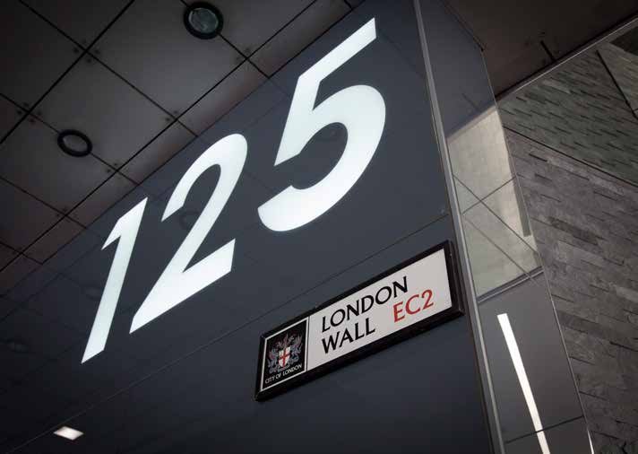 Building sign for "125 London Wall EC2" with the City of London crest.