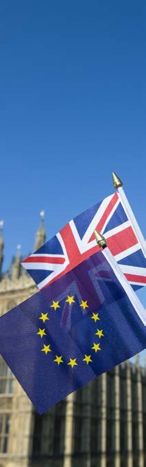 Small Union Jack and European Union flags flying together against a blue sky, symbolizing UK-EU relations.