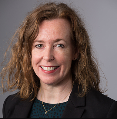 Headshot of a smiling woman with shoulder-length brown hair.