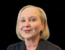 Headshot of a smiling woman with blonde hair, wearing a black top and gold earrings.