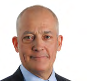 Headshot of a smiling bald man wearing a dark suit and light blue shirt.