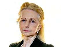 Headshot of a woman with light hair and pearl earrings looking forward.