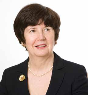 Portrait of an older woman with short dark hair, wearing a pearl necklace and brooch.