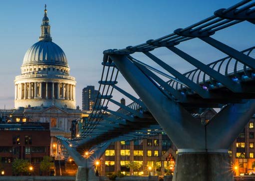 St Paul's Cathedral and the Millennium Bridge against a dusk sky in London.